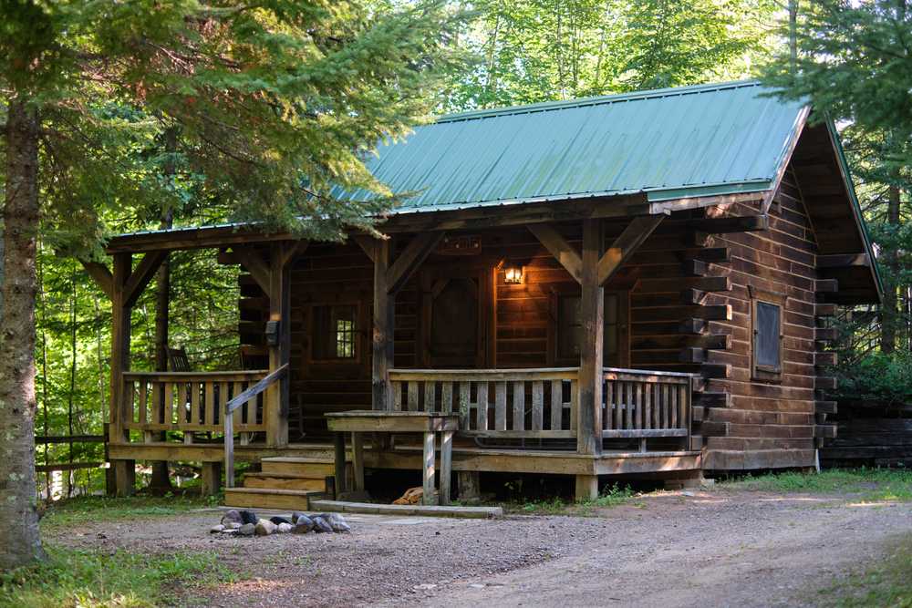 A cabin surrounded by trees at Heaven’s Up North Campground