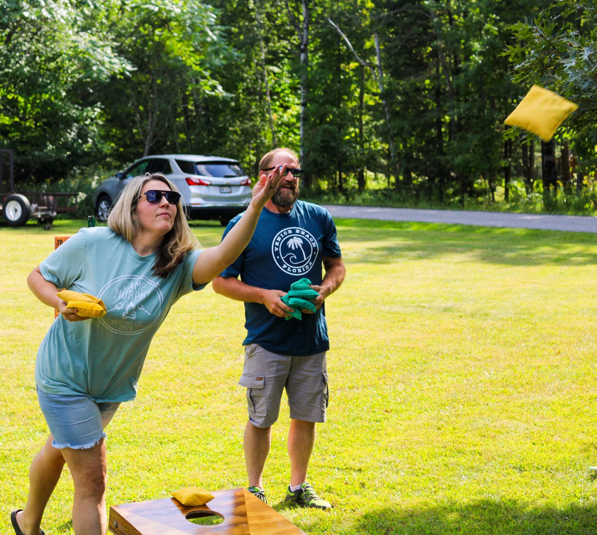 Guests playing cornhole at Heaven’s Up North Campground