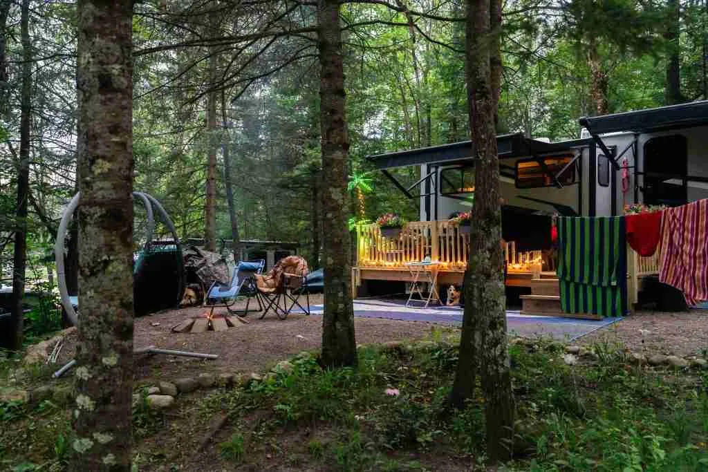 Long-term RV site with a deck and shaded campsite setup
